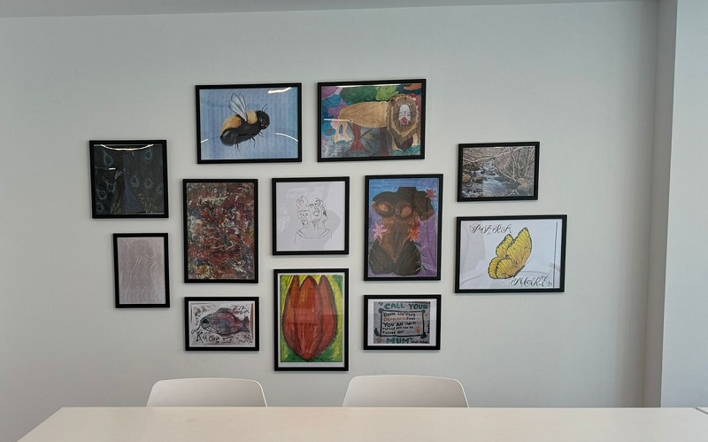 Some of the service user artwork on the wall at our Birmingham office