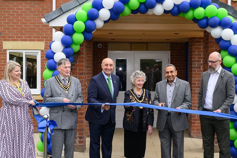 Dr George El-Nimr cutting the ribbon to open Cygnet Paddocks.